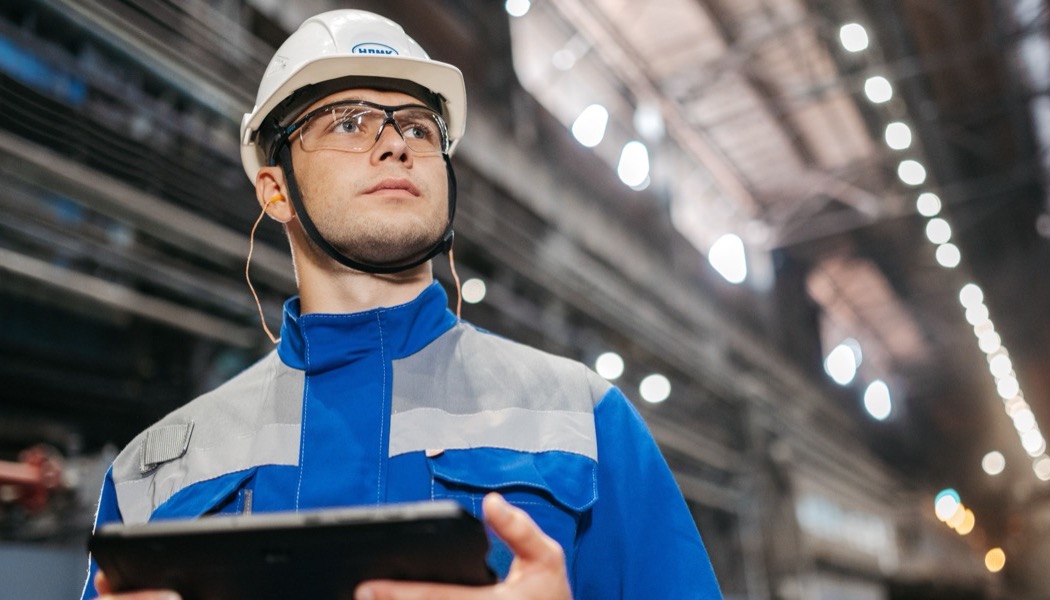Field technician holding a tablet after completing master valve service at Well Pad 27A
