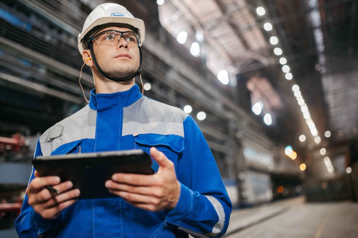 Field service technician completing work on a tablet