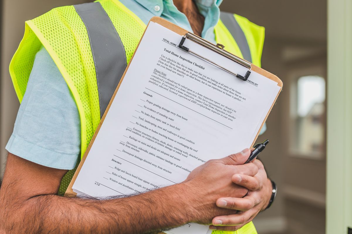 Technician holding a paper inspection checklist